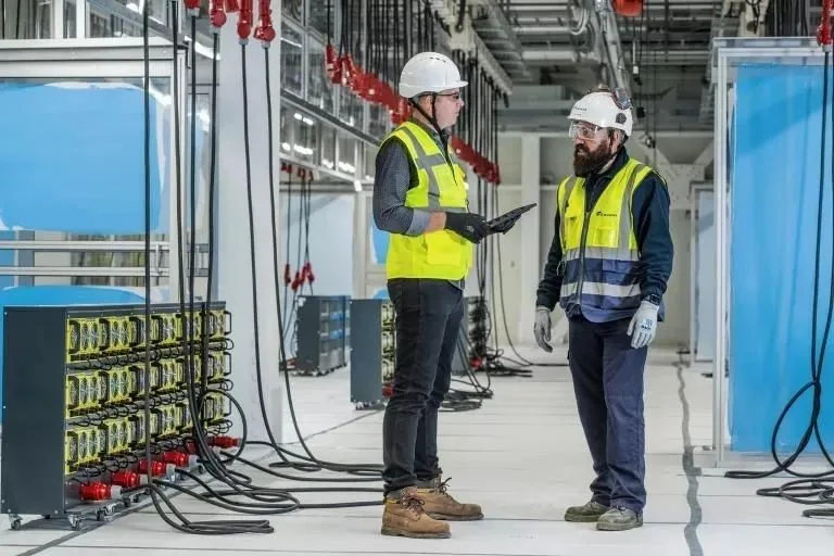 Two SESG engineers reviewing test results on a project site