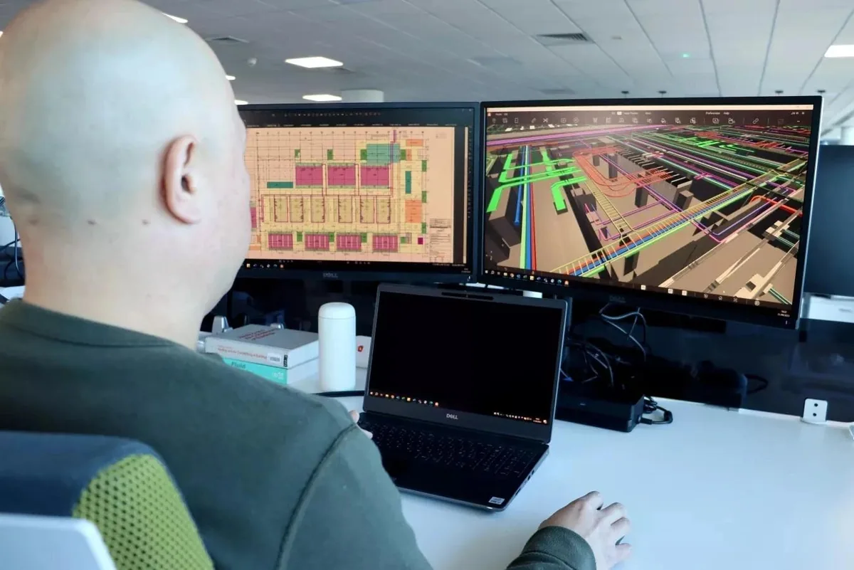 Engineer monitoring facility systems from a workstation