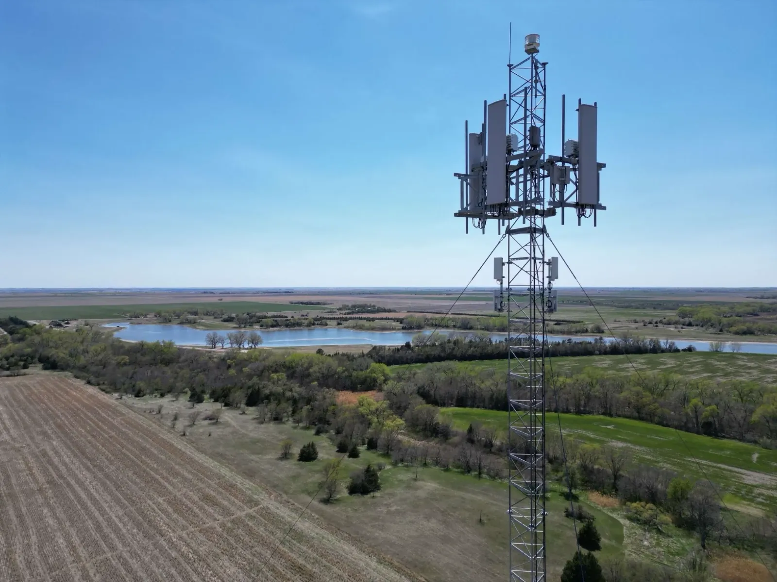 AT&T cell tower with antennas and radio units above the Kansas countryside near Axtell